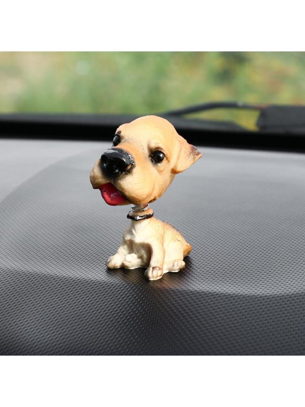 Собака на панель авто, качающая головой, уэльский терьер